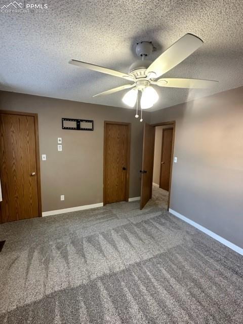 Image 20 of 24: Carpeted empty room with a ceiling fan and a textured ceiling