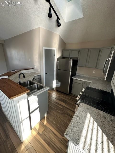 Image 3 of 24: Kitchen with gray cabinets, track lighting, stainless steel appliances, dar