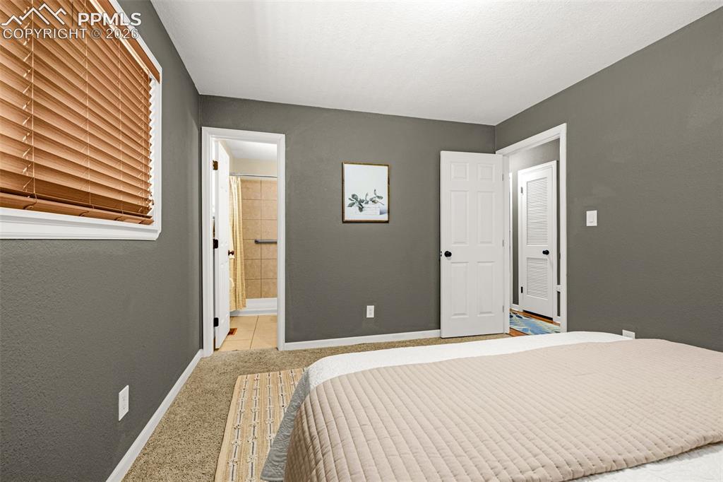 Image 10 of 21: Bedroom with ensuite bath