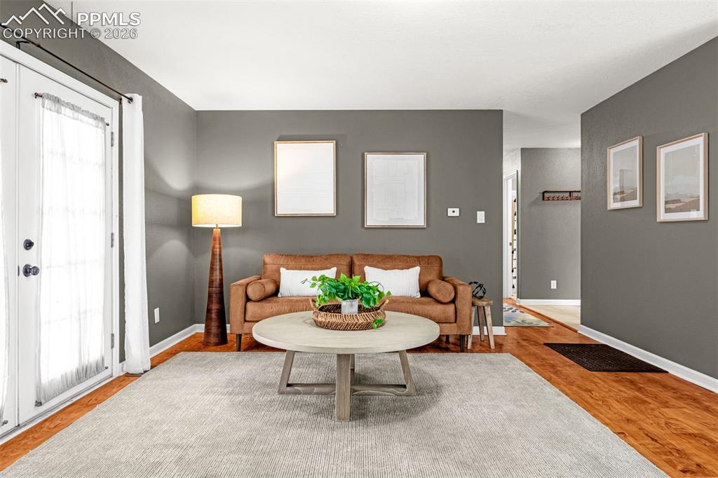 Image 15 of 21: Livingroom French doors with Walkout to huge fenced backyard