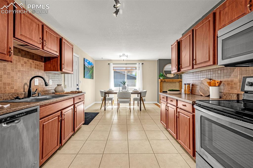 Image 5 of 21: Galley kitchen with dining room
