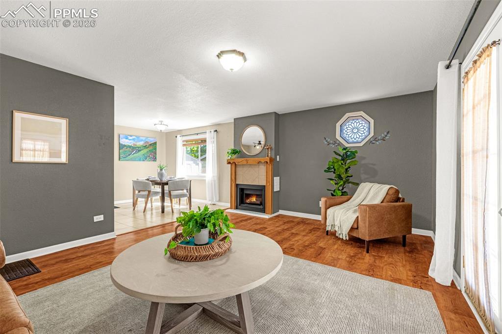 Image 7 of 21: Wood floors, fireplace and open floor plan