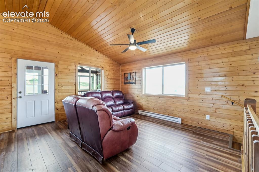 Image 17 of 33: Wood paneling throughout, vaulted wood-plank ceiling, wood-finish flooring,