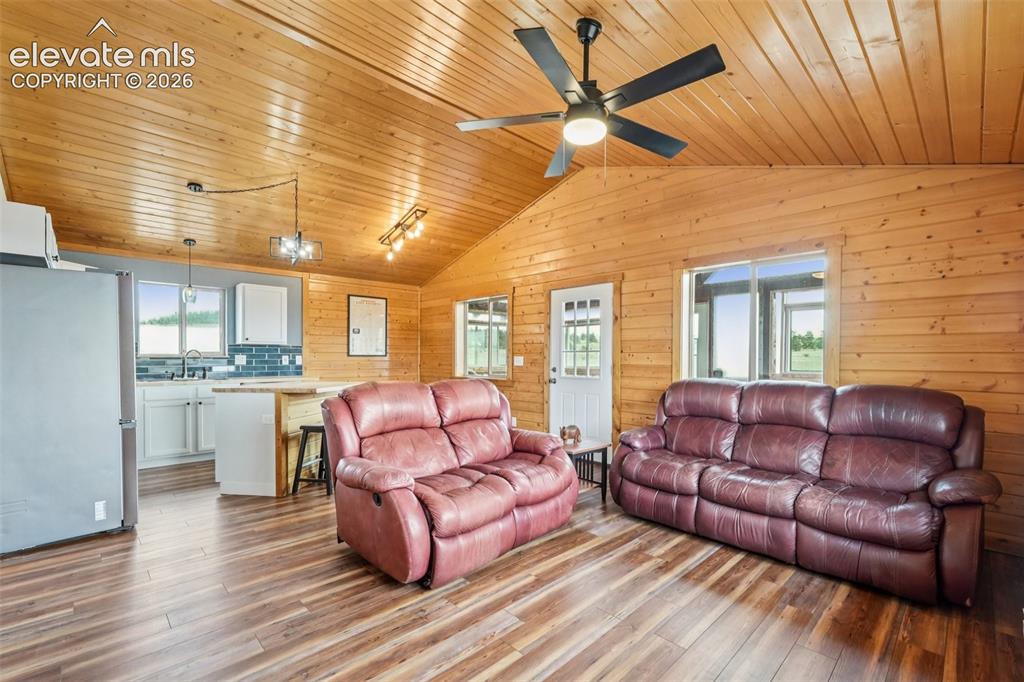 Image 18 of 33: Vaulted wood-paneled ceilings with exposed beams, wood-finish flooring, and