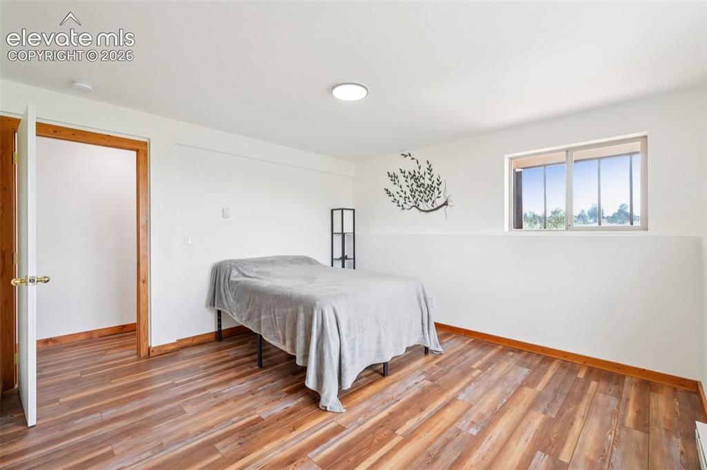 Image 23 of 33: Wood-finish flooring throughout, featuring a recessed ceiling light, white 