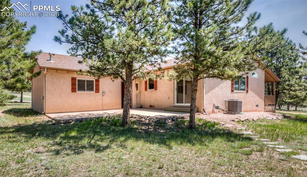 Image 11 of 50: L-shaped concrete back patio. that walks out from the kitchen for more spac