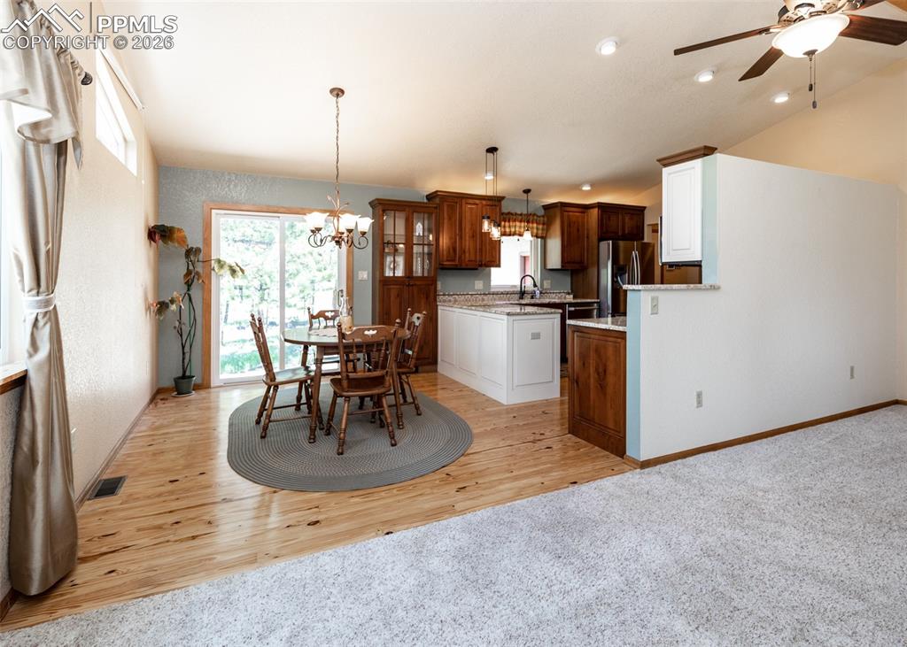 Image 16 of 50: Living room into dining and kitchen. Perfect floorplan for family activitie