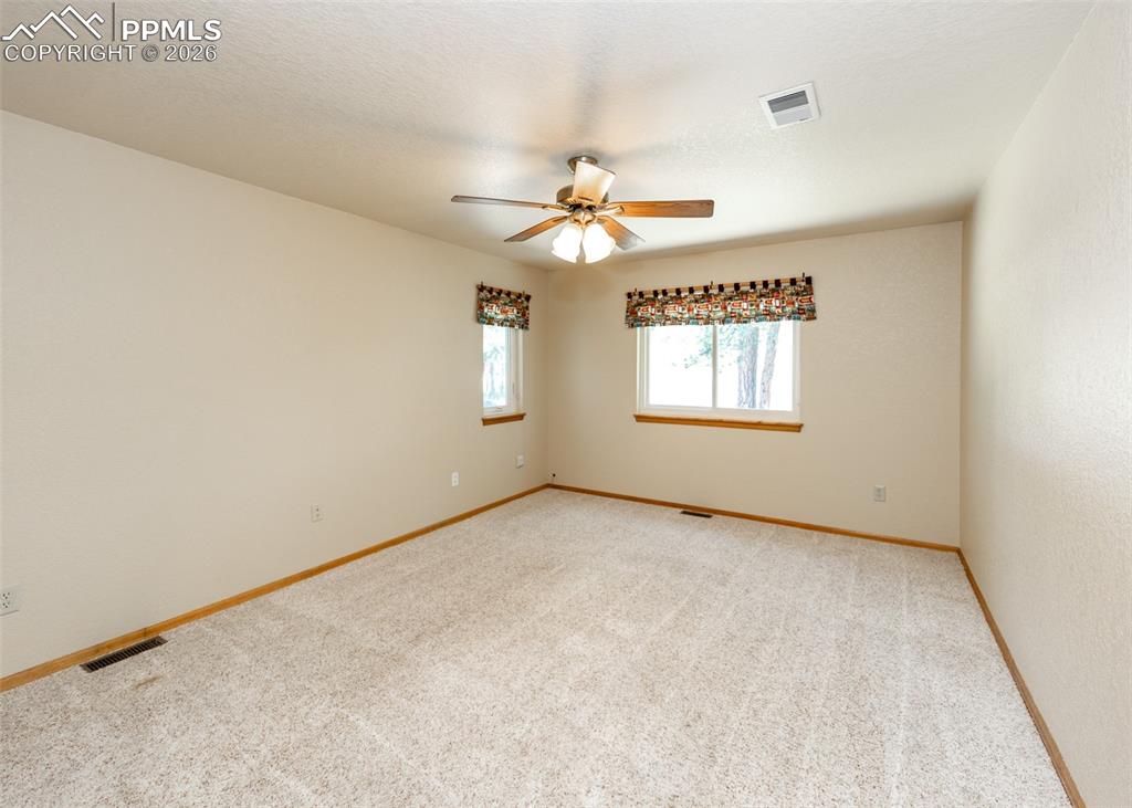 Image 36 of 50: Another view of secondary bedroom (2)/office with lots of light.