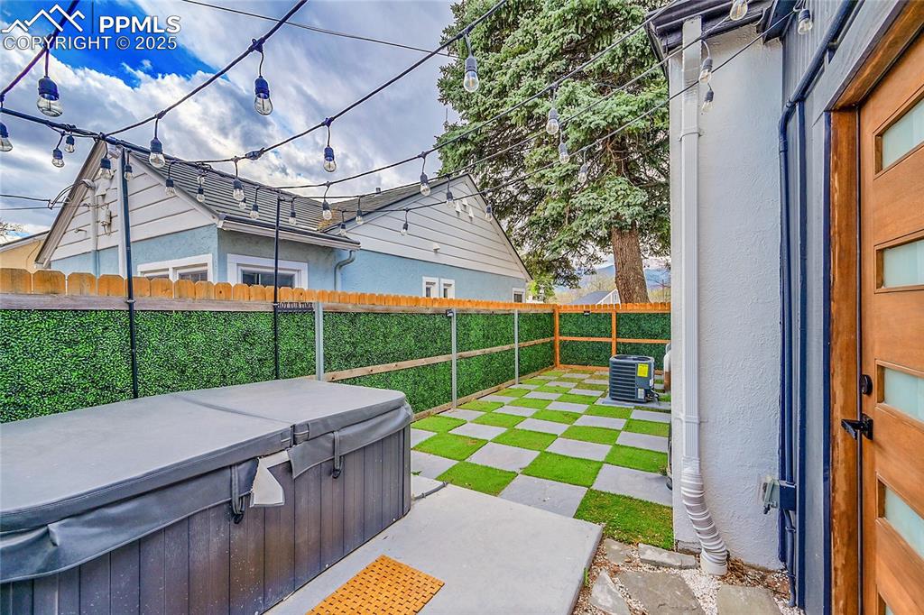 Image 13 of 25: Private patio off the primary bath with two person hot tub (included)