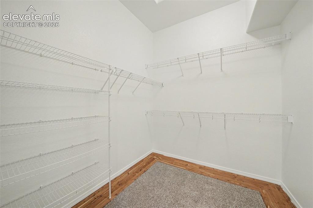 Image 22 of 41: Generous walk-in closet provides plenty of storage in the primary suite.