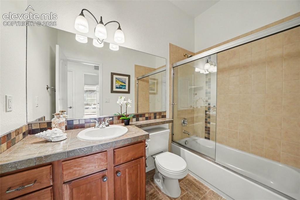 Image 25 of 41: Full bath conveniently located near the second main-level bedroom.