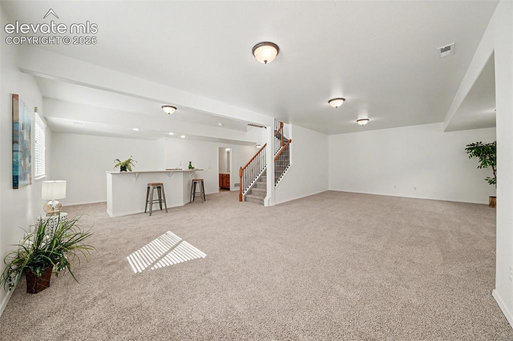 Image 26 of 41: Finished basement with brand-new carpet.