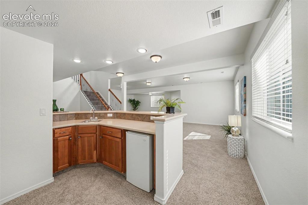 Image 29 of 41: Basement wet bar makes entertaining and gathering with family and friends e