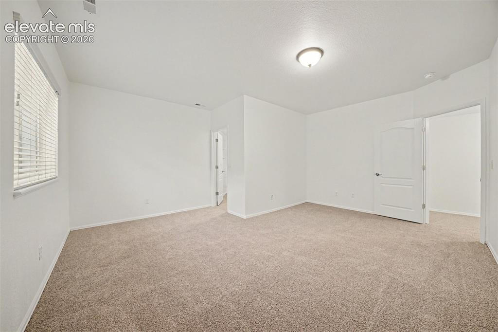 Image 33 of 41: Two generously sized basement bedrooms offer plenty of space for family, gu