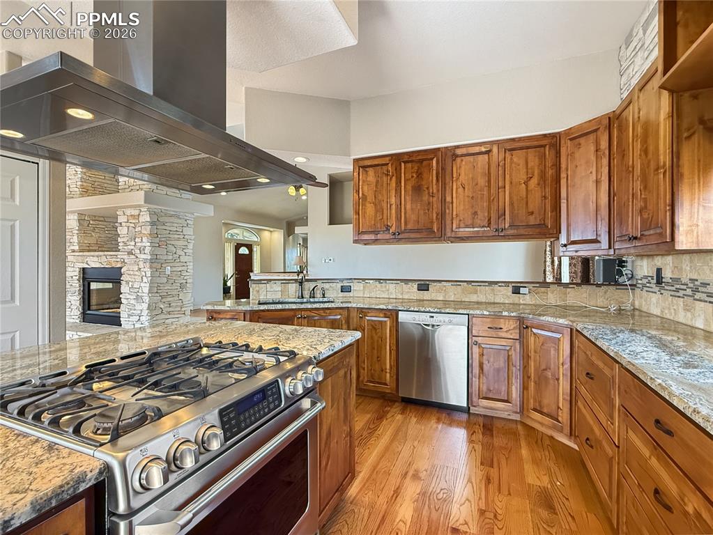 Image 12 of 50: Stove is gas on top and electric for the oven