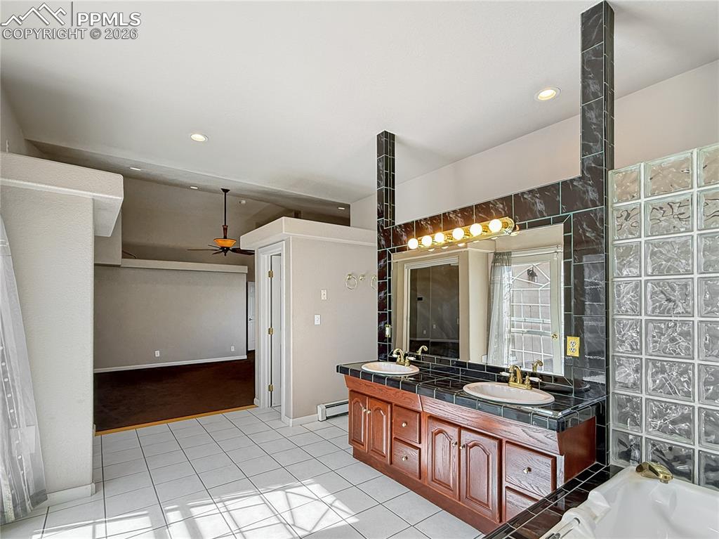 Image 19 of 50: Large bathroom with double vanity and another closet for storage