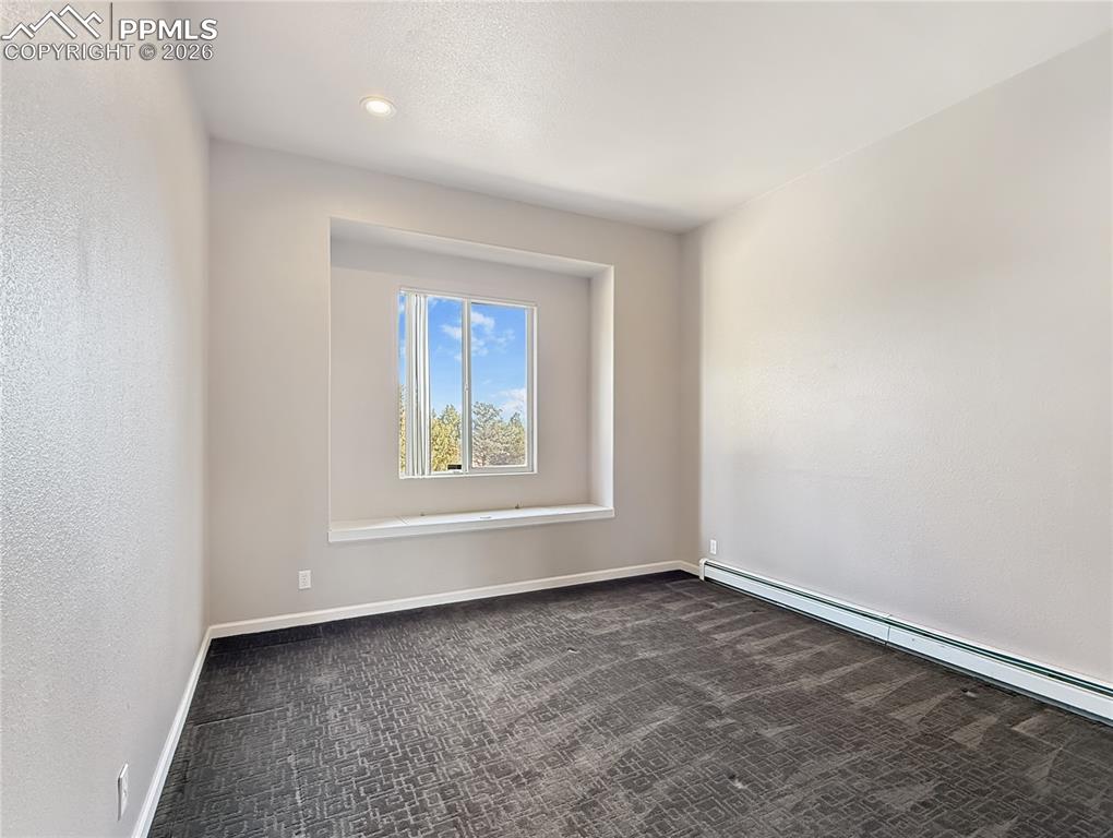 Image 24 of 50: Bedroom 2,  has storage under the window seat