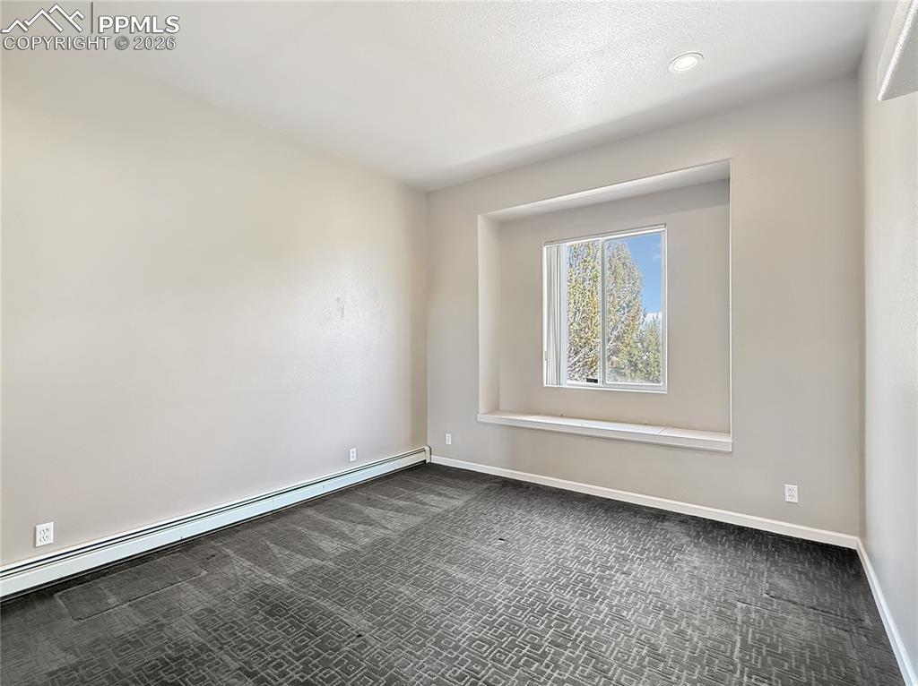 Image 28 of 50: Bedroom 3,  has storage under the window seat