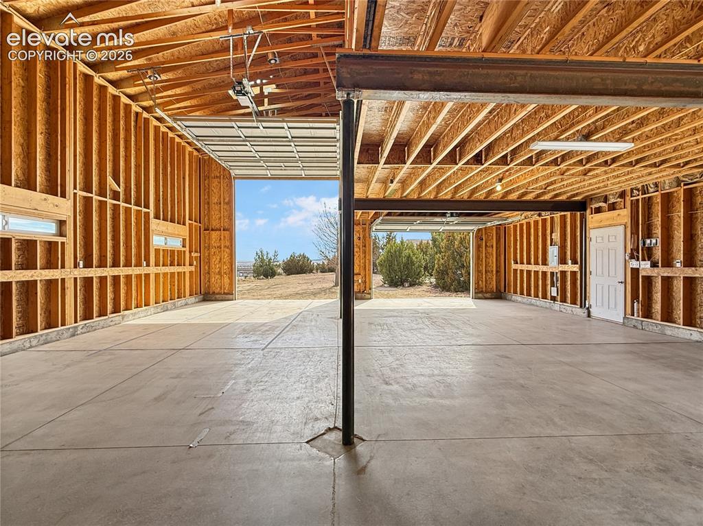 Image 40 of 50: Detached garage looking from back to front, notice the extra large door for