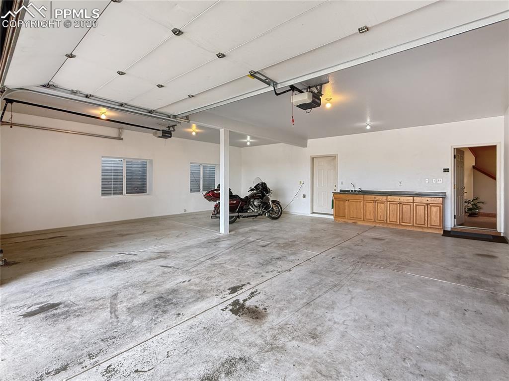Image 44 of 50: Detached garage looking from back to front, notice the extra large door for