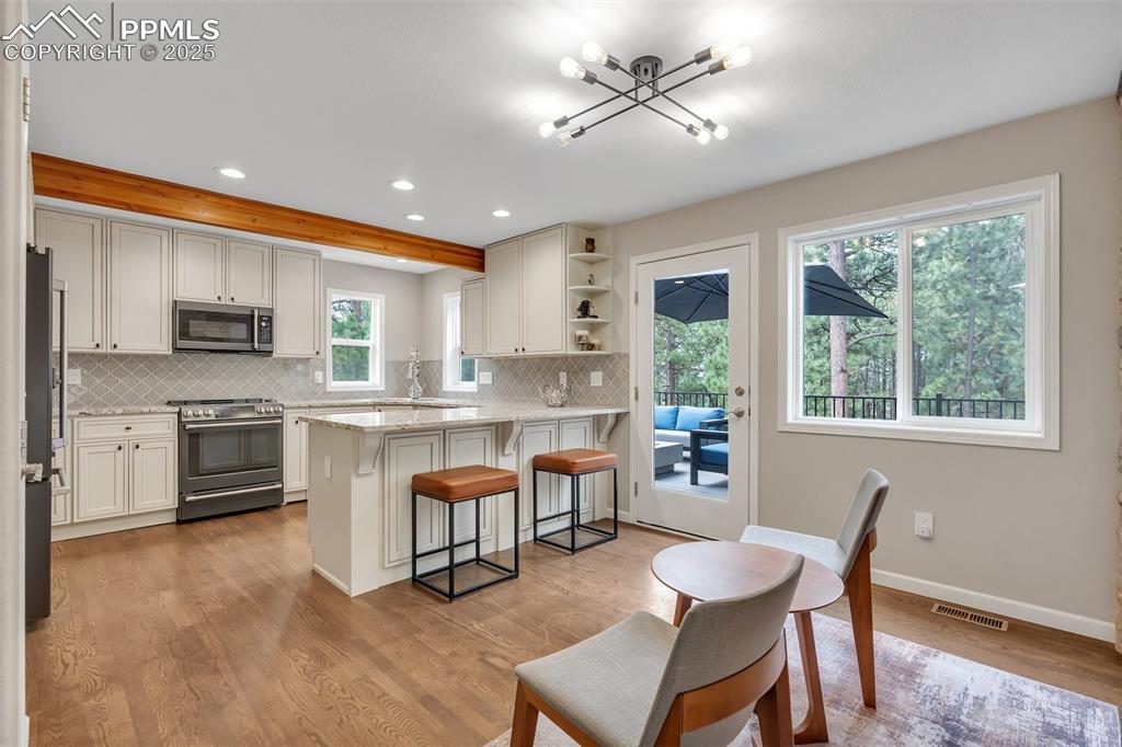 Image 11 of 50: Kitchen featuring recessed lighting, stainless steel appliances, backsplash