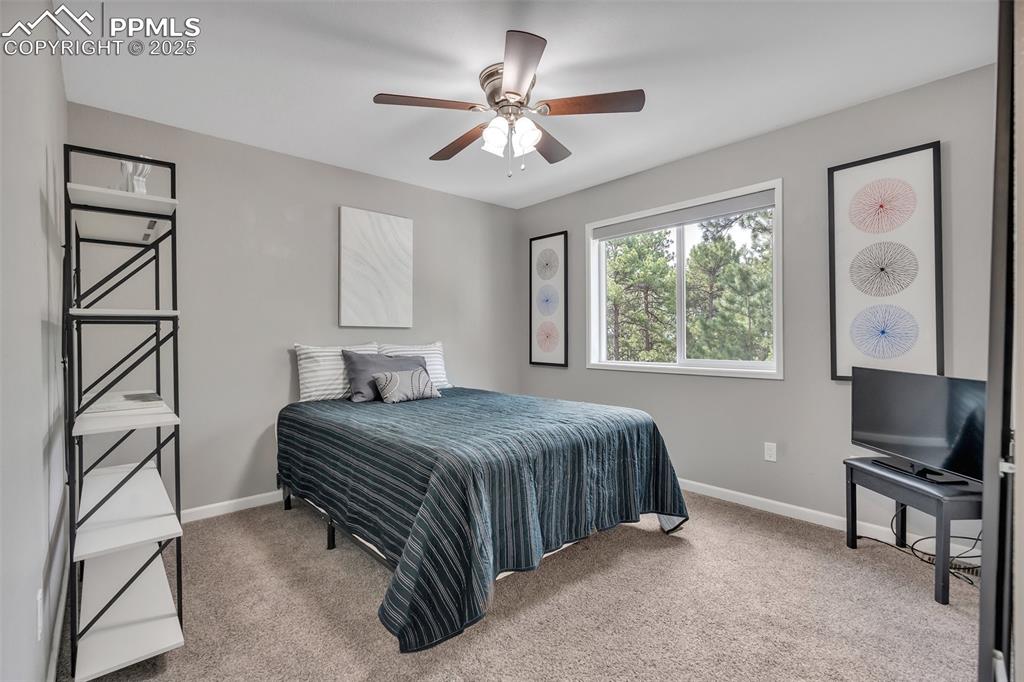 Image 32 of 50: Bedroom featuring carpet floors and ceiling fan