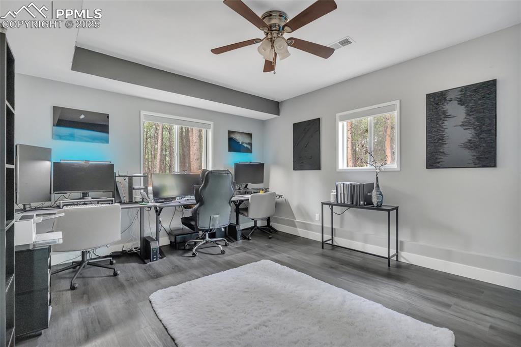 Image 42 of 50: Home office featuring wood finished floors and a ceiling fan