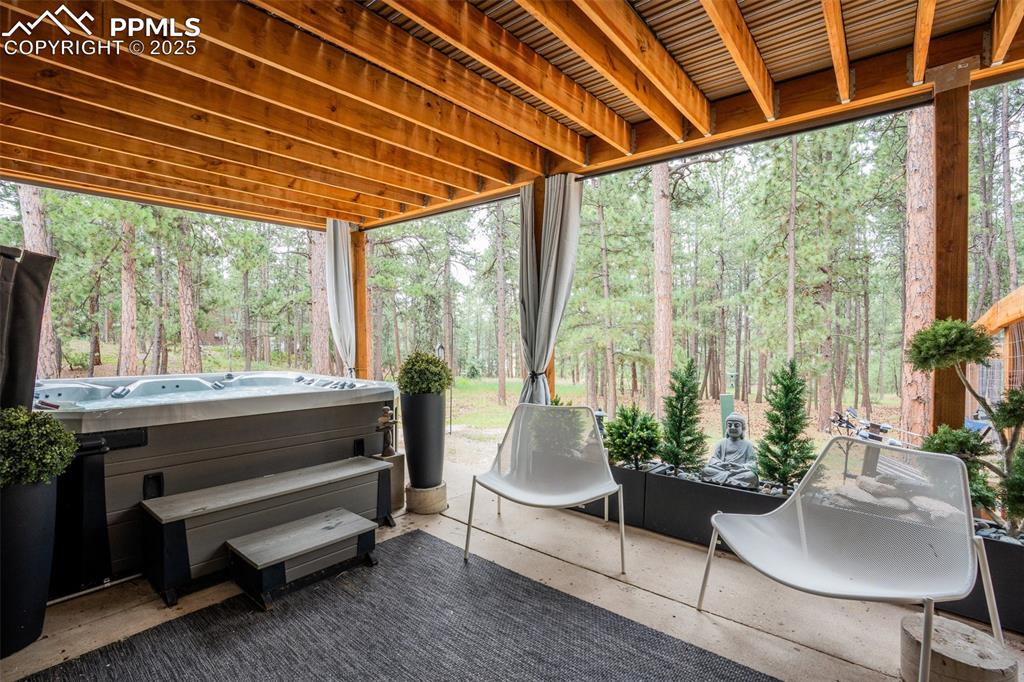 Image 44 of 50: Sunroom / solarium featuring a jacuzzi, plenty of natural light, and a view