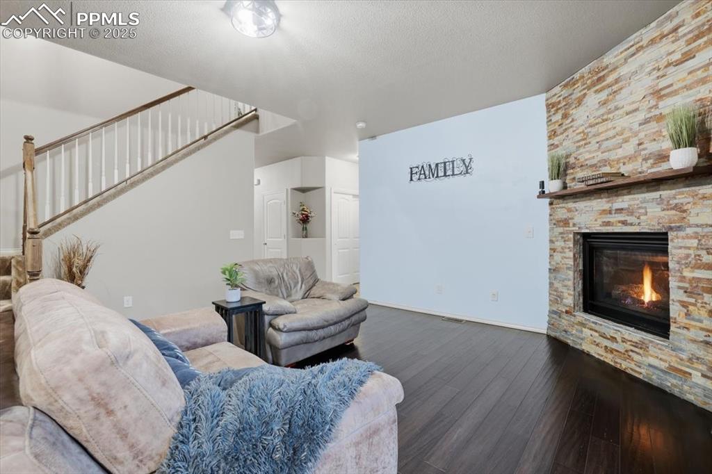 Image 16 of 50: The hallway beyond the living area leads to the half bath and private offic