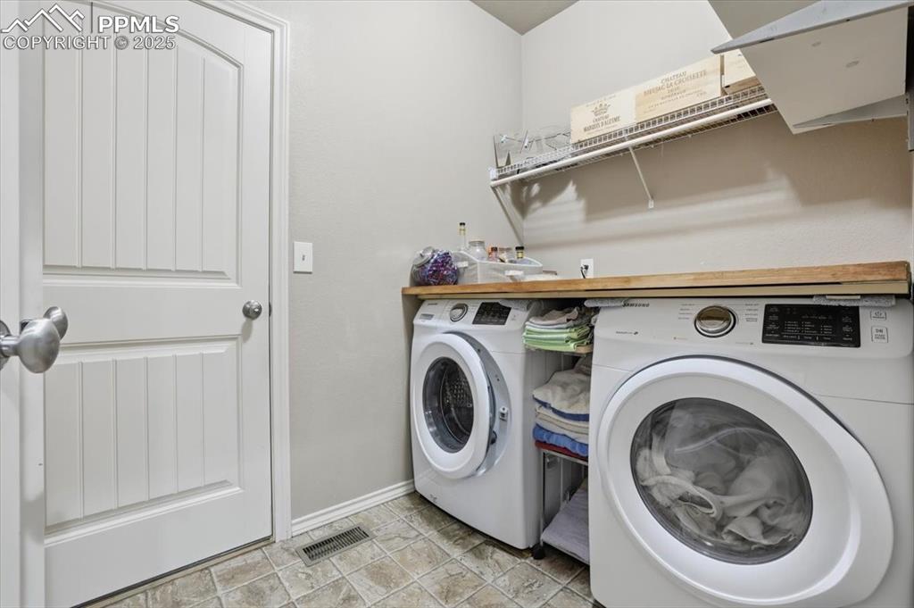 Image 18 of 50: The main-floor laundry is located between the kitchen and the garage. 