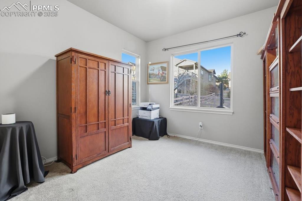 Image 19 of 50: This separate office is located in the back of the main level and could als