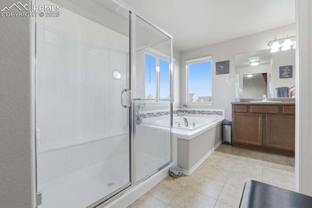 Image 26 of 50: The primary bathroom is spacious and filled with natural light.