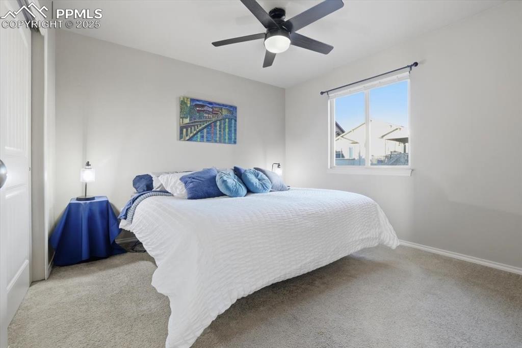 Image 28 of 50: The second bedroom on the upper floor has room for a king-sized bed and all