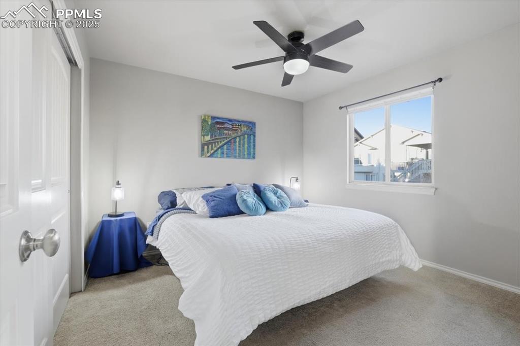 Image 29 of 50: The second bedroom on the upper level has a double closet. 