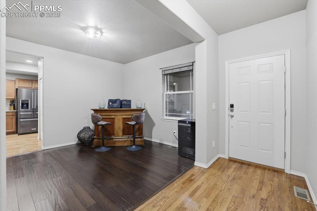 Image 3 of 50: The entry is open to the formal dining room, which could also be used as an