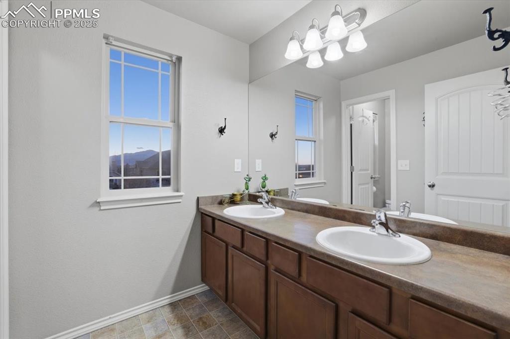 Image 30 of 50: This second upper-level bath also has dual vanities and plenty of counter s