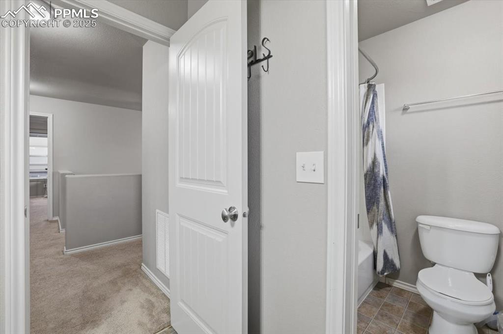 Image 31 of 50: The second upper level bathroom has a tub/shower combo and serves the secon