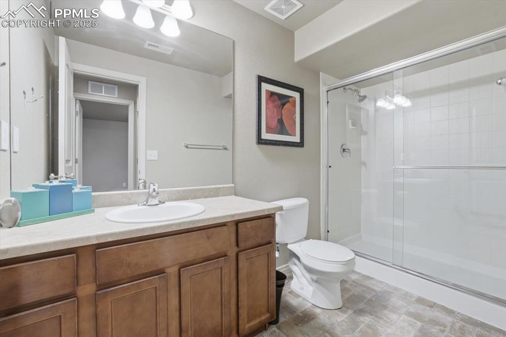 Image 44 of 50: The basement level bath has a large double shower and lots of counter space