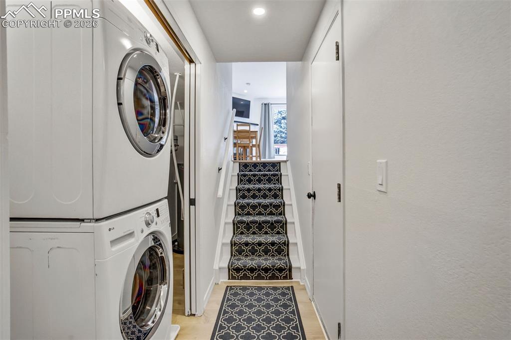 Image 31 of 39: Laundry (with great storage as well) is trucked behind pocket doors. 