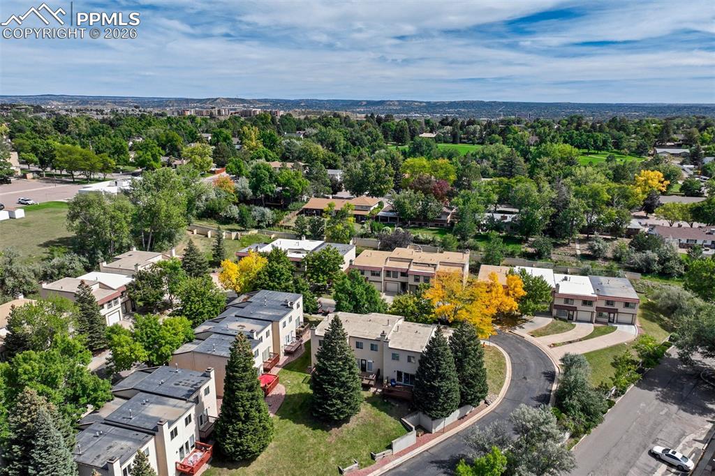 Image 36 of 39: Back of the townhouse with green space. 