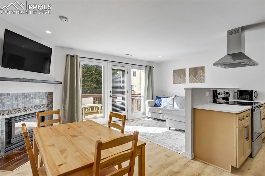 Image 5 of 39: Kichen, dining room, and living room on the main level. New flooring, new p