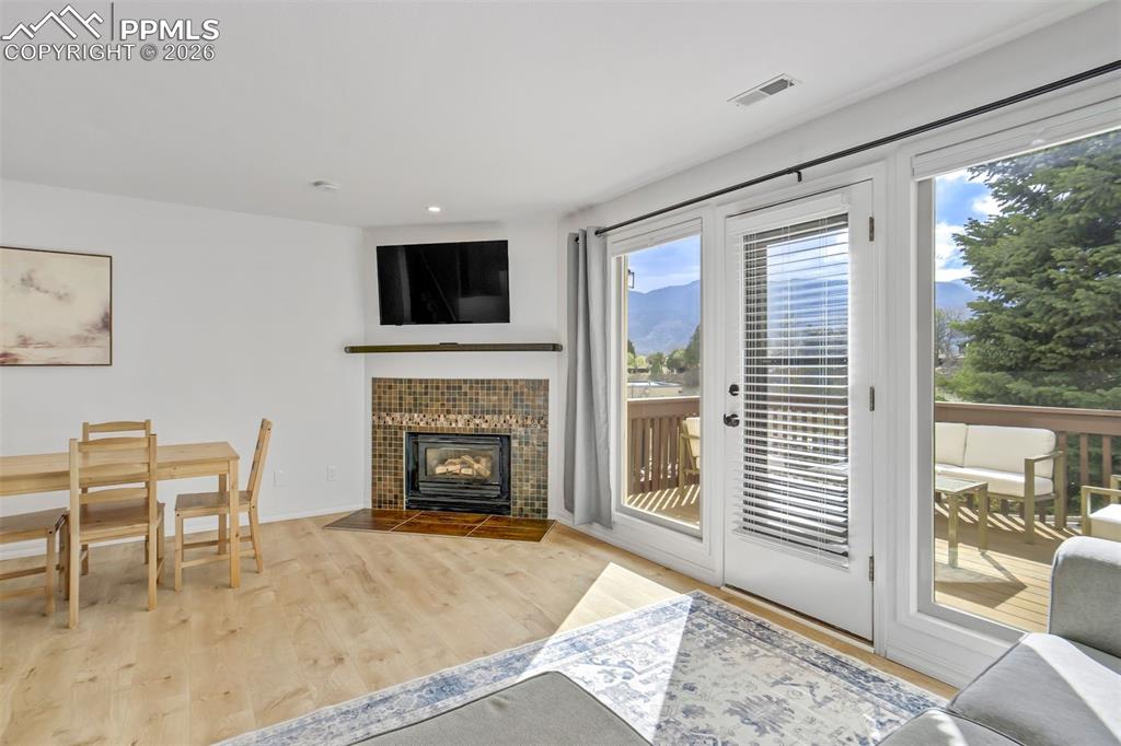 Image 8 of 39: Fireplace can be enjoyed in the living room & dining area. 