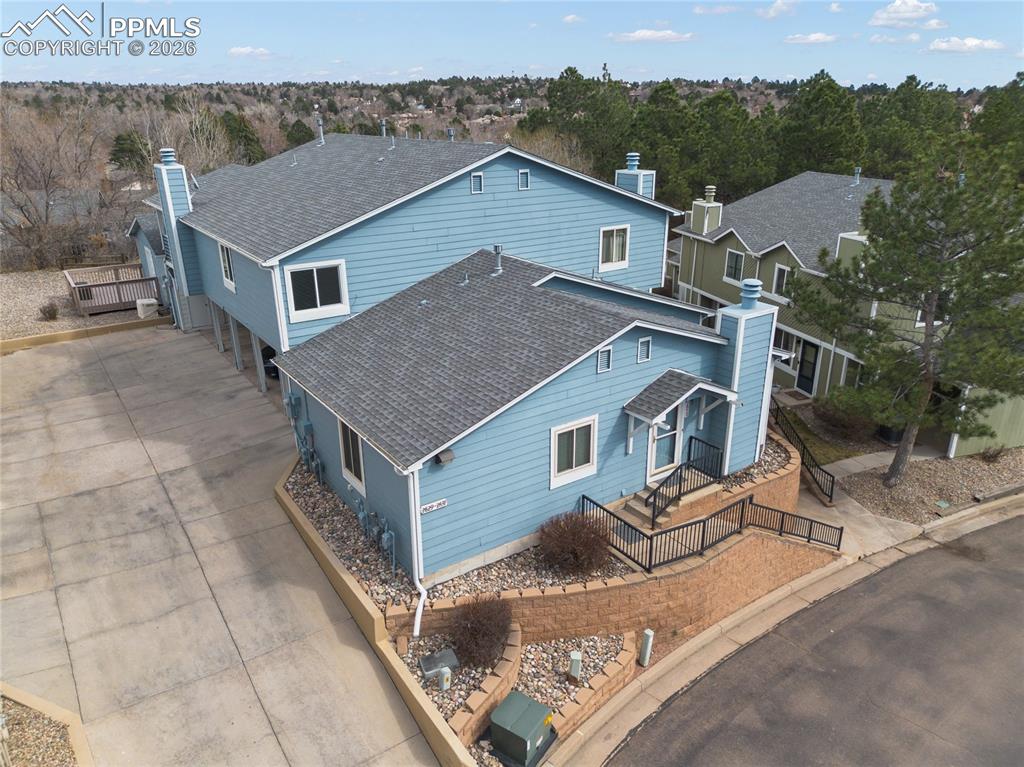 Image 1 of 16: View of front of property featuring a shingled roof, a chimney, a wooden de