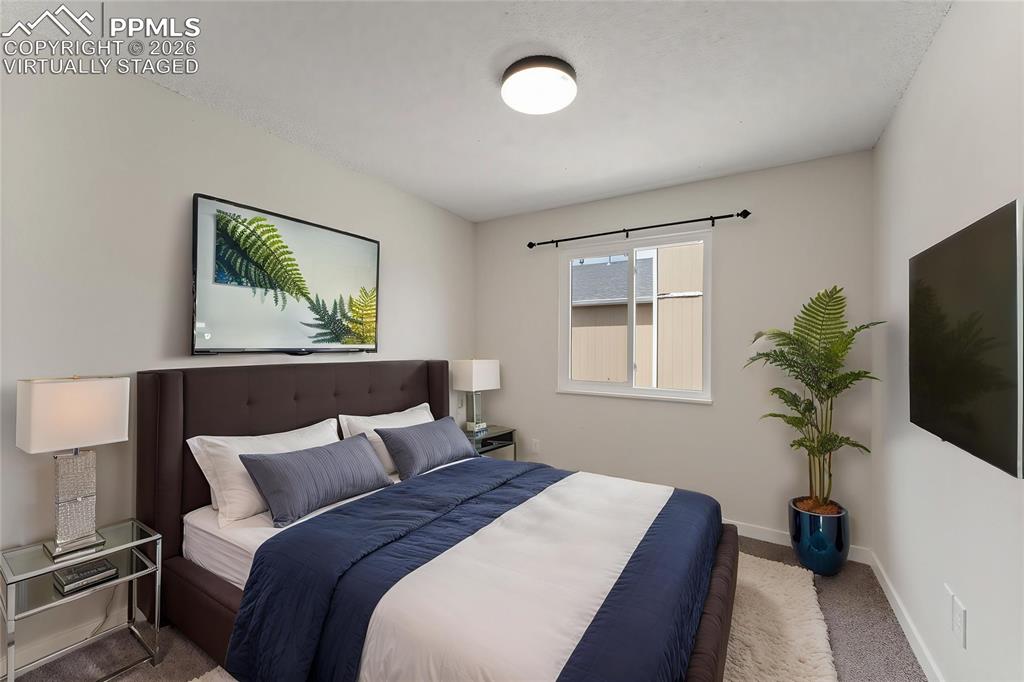 Image 12 of 16: Carpeted empty room with a textured ceiling and baseboards