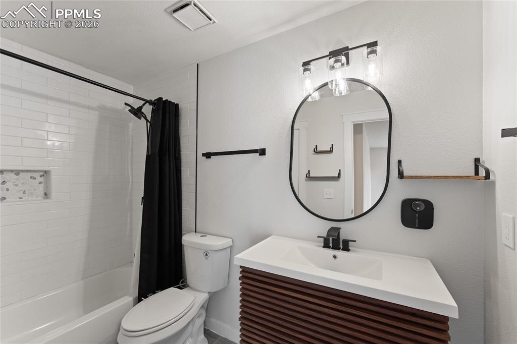 Image 14 of 16: Unfurnished room featuring dark carpet and a textured ceiling