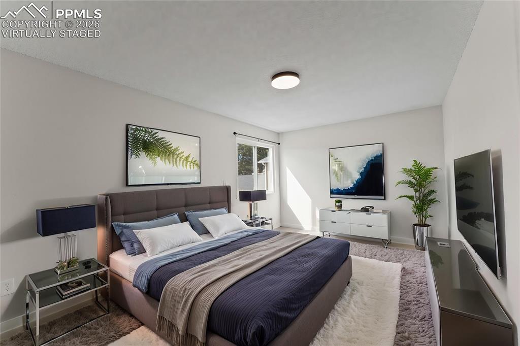 Image 9 of 16: Kitchen with stainless steel appliances, white cabinets, light wood-style f