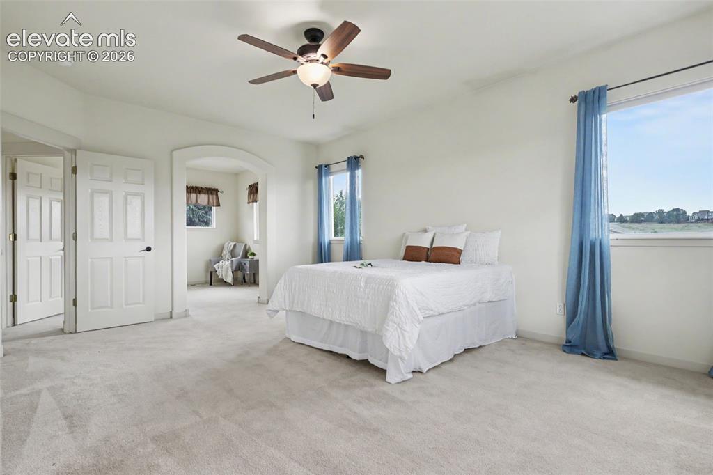 Image 16 of 47: Spacious room featuring light-toned carpet, a vaulted ceiling, and a ceilin