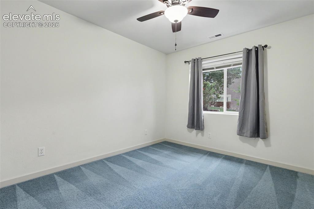 Image 30 of 47: Room featuring light blue patterned carpeting, a ceiling fan with integrate
