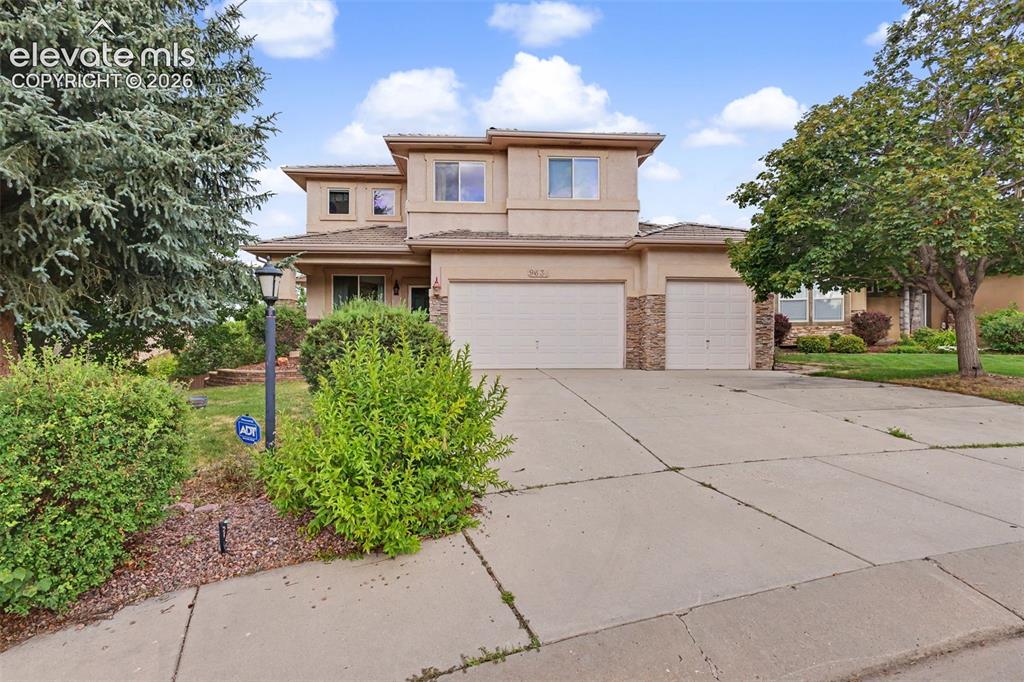 Image 40 of 47: Stucco exterior featuring stacked stone accents, two-story construction, an