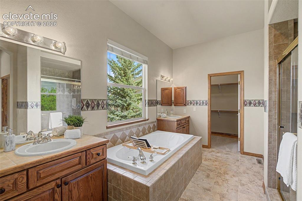 Image 26 of 50: 5-piece primary bath with dual sinks, large shower and tub